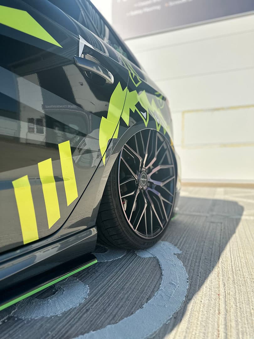 2016 Audi A3 S line Sportback 2.0L TDI with a custom wrap with acid yellow, black, and white decals created by Wraptor Customs